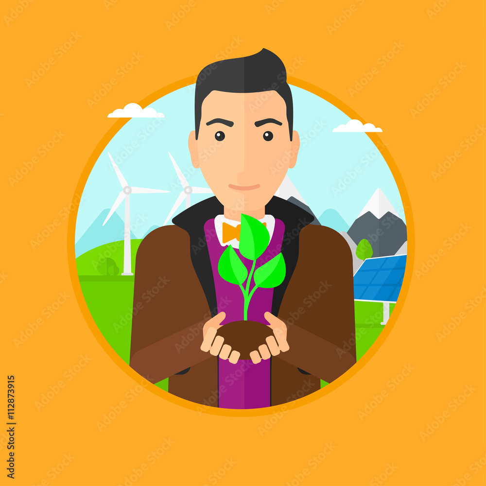 Obraz premium Man holding green small plant.