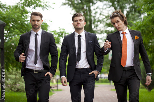 Three young men in elegant business suits