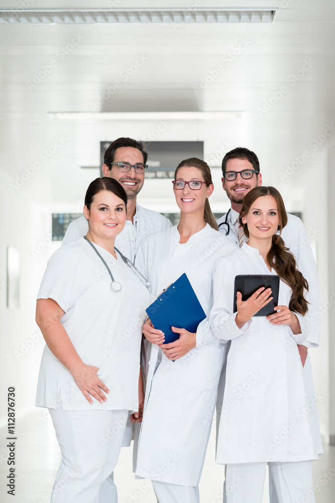 Team of doctors standing in hospital corridor Team of doctors standing in hospital corridor