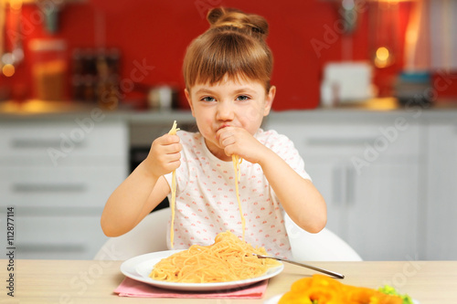 Adorable little girl eating...
