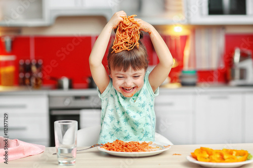 Adorable little girl eating...