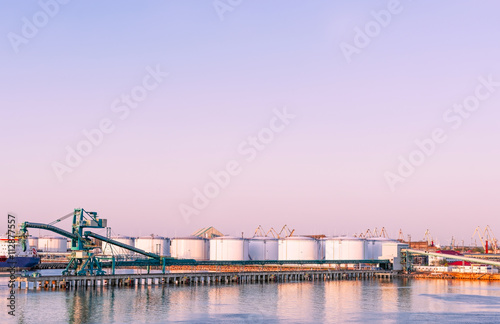 Oil bunkers at Marina in Ventspils at sundown photo