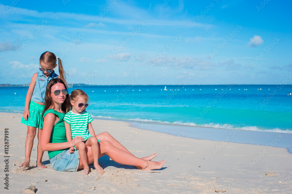 Mother and daughters enjoying time at tropical beach