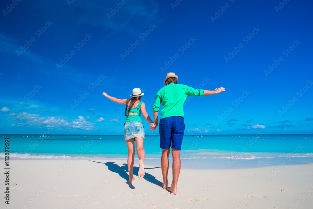 Young couple on white beach at summer vacation