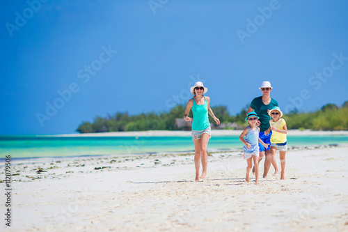Happy family of four on the beach © travnikovstudio