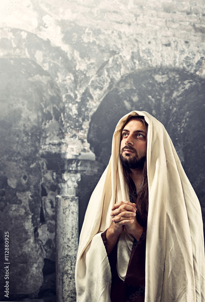 Jesus Christ prays with clasped hands - obrazy, fototapety, plakaty 