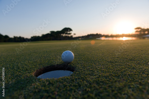 golf ball on edge of  the hole