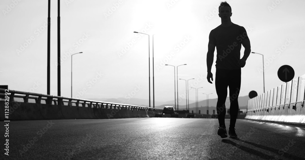 Running at sunrise man exercising for marathon and workout fitne Running at sunrise man exercising for marathon and workout fitne