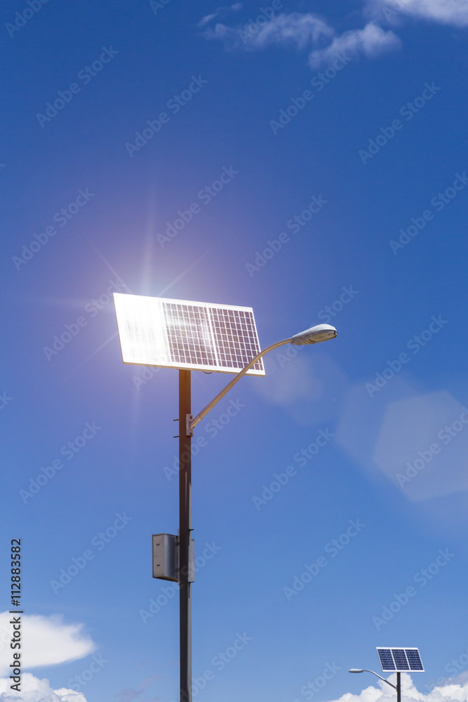 Solar panels on lamp posts reflecting sunlight to produce renewable green electric power for public infrastructure utilities Solar panels on lamp posts reflecting sunlight to produce renewable green electric power for public infrastructure utilities