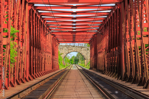 Fototapeta Naklejka Na Ścianę i Meble -  Railroad on a red bridge in summer day