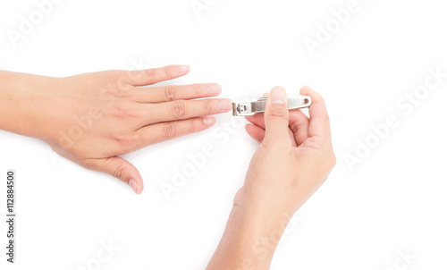 Closeup women cutting fingernails on white background