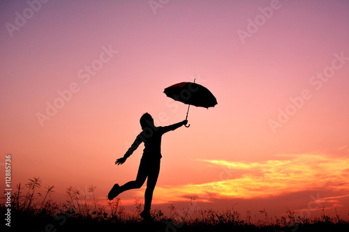 Silhouette women and umbrella in the sunset © sawitreelyaon
