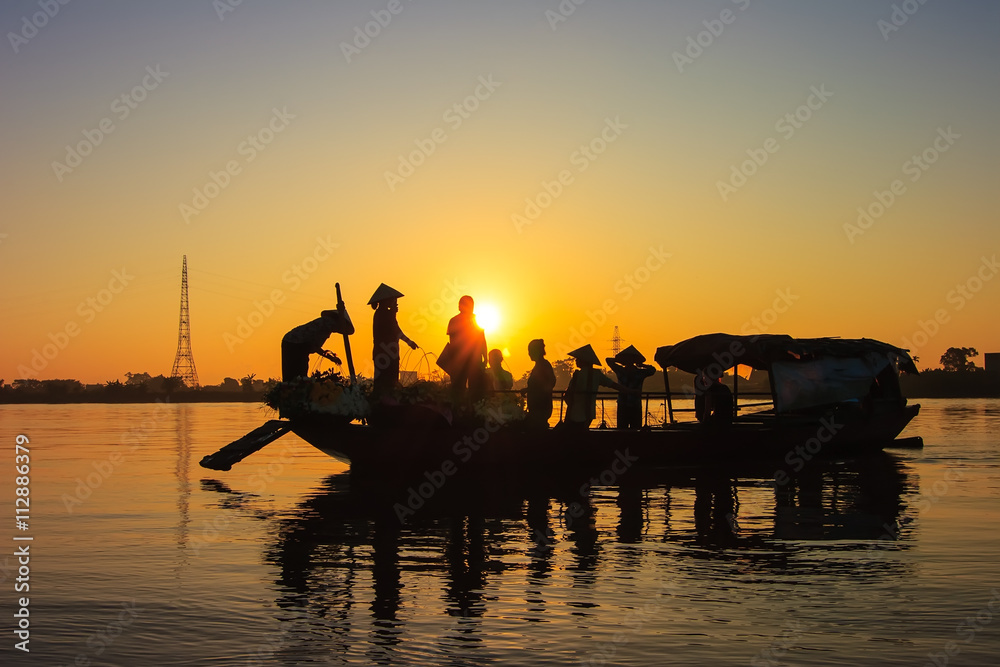 Fishermen in a boat at sunset