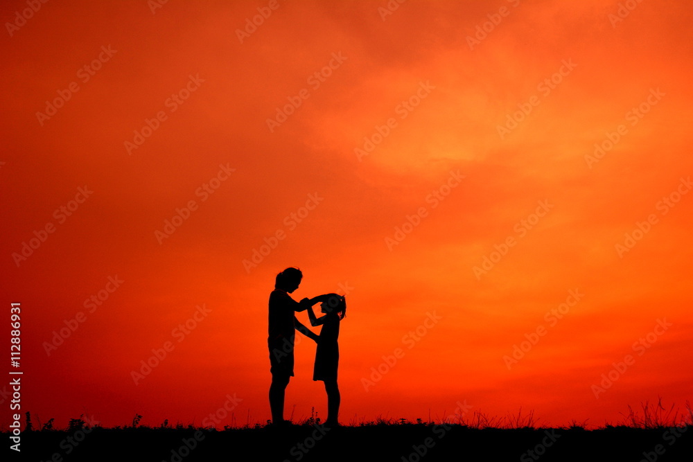 Silhouette mother and daughter in the sunset Silhouette mother and daughter in the sunset