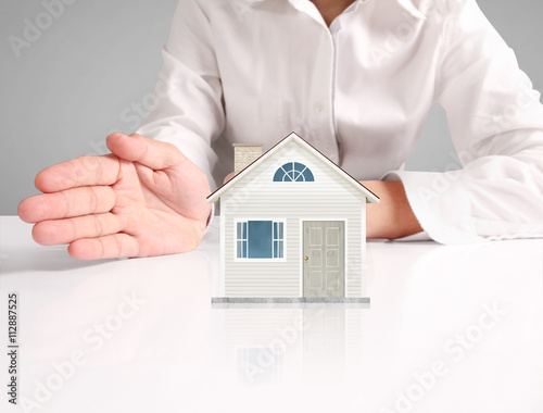Mortgage concept by house from hand