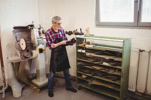 Cobbler making a shoe with a hammer