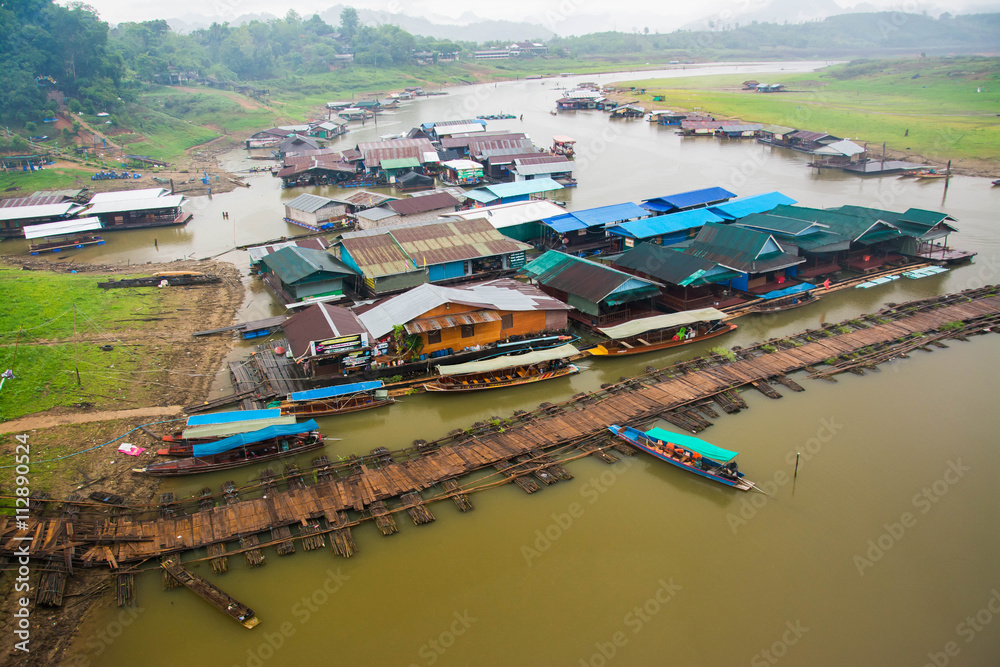 Houseboat and old wooden bridge in Sangkhla Buri,Kanchanaburi province, Thailand