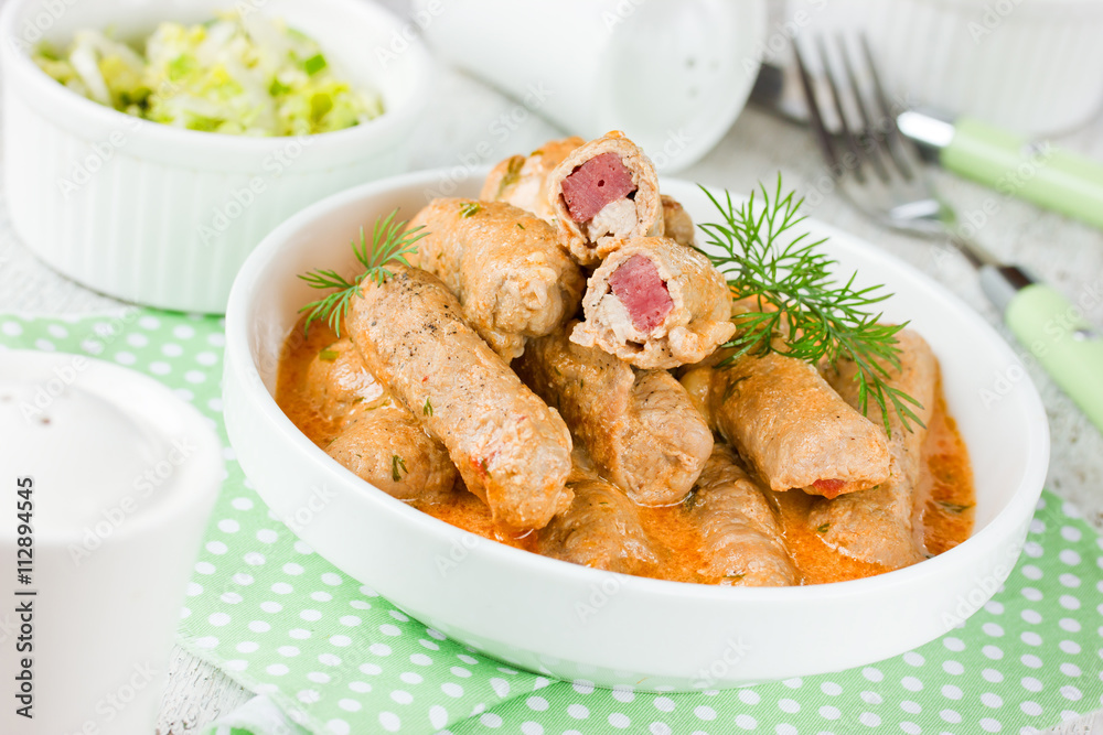 Meat fingers of pork fillet with ham stuffing in sauce Meat fingers of pork fillet with ham stuffing in sauce