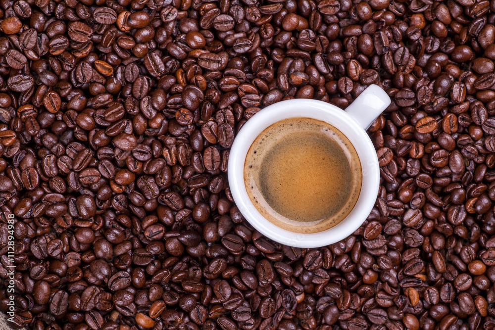 Cup on coffee beans