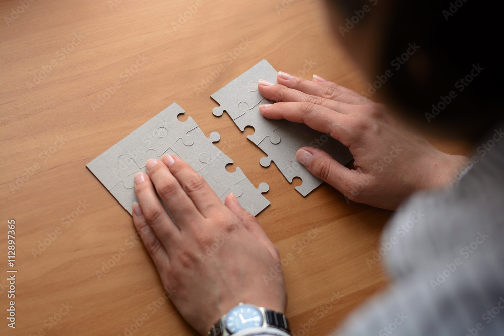 Folding puzzle hand parts on a wooden table