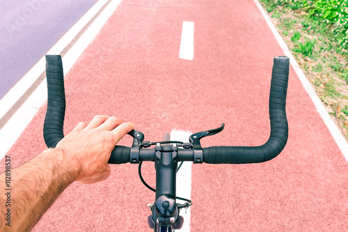 Man riding sport bike top view on handle bar and road perspectivive - Concept of alternative environmental friendly transportation