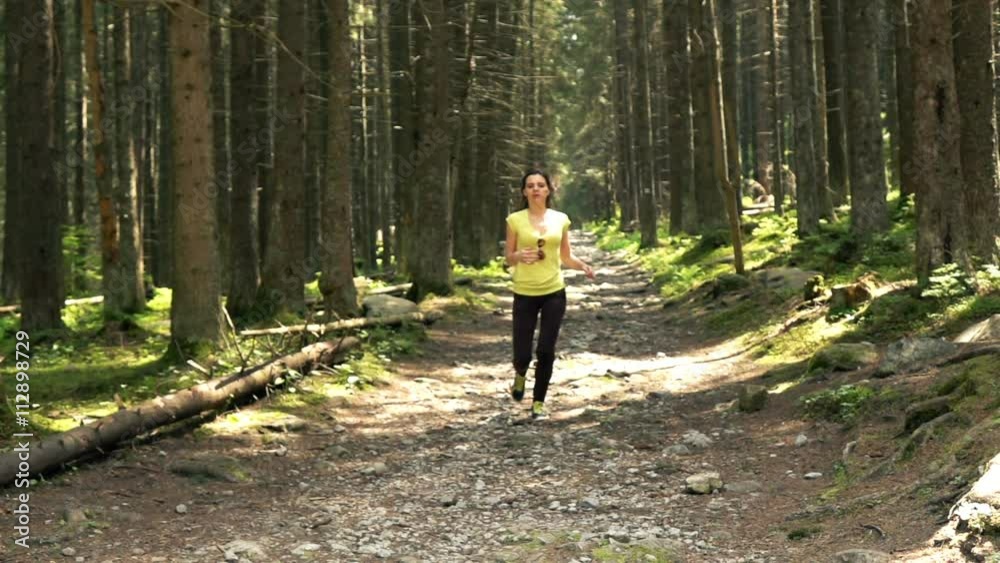 Young, sporty woman jogging in forest, super slow motion 240fps
Young, sporty woman jogging in forest, super slow motion 240fps