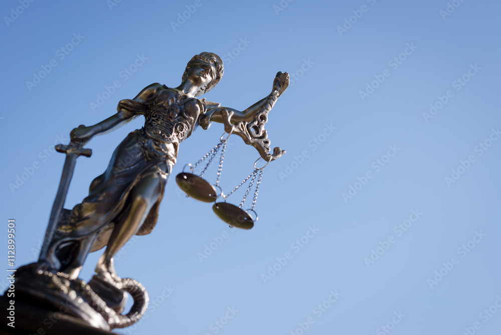 sculpture of themis, femida or justice goddess on bright blue sky background sculpture of themis, femida or justice goddess on bright blue sky background