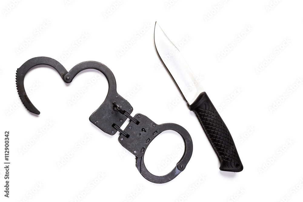 Handcuffs and knife on white isolated background Handcuffs and knife on white isolated background