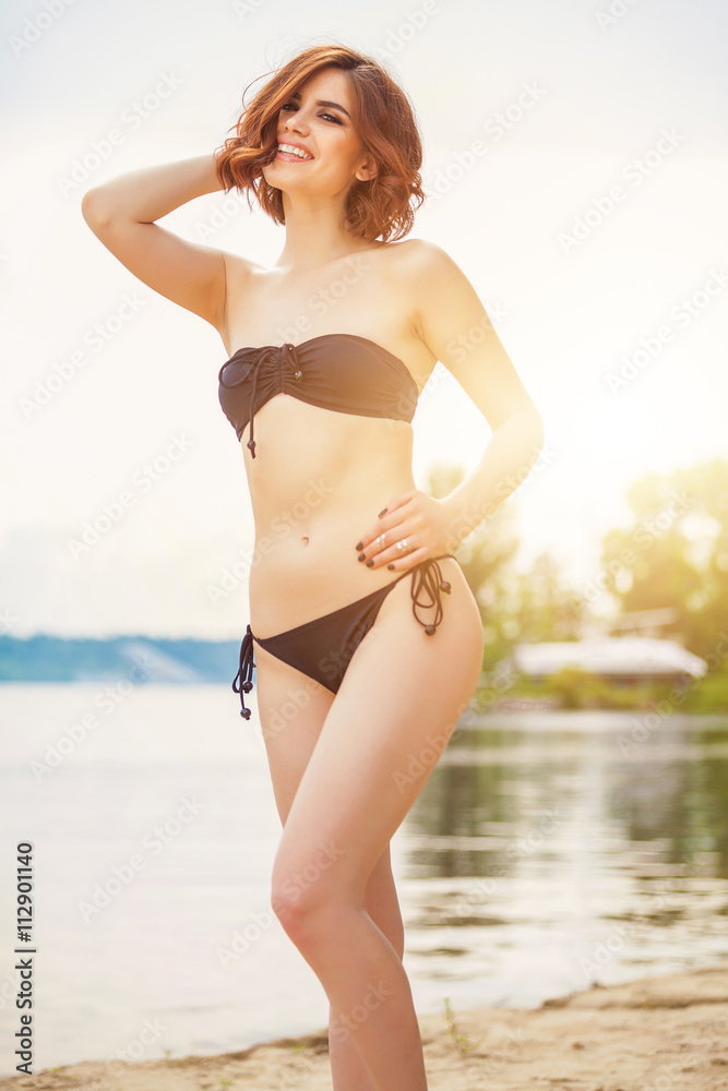 Beautiful woman with black bikini relaxing on the beach. Happy day, summer day, Sunshine Girl