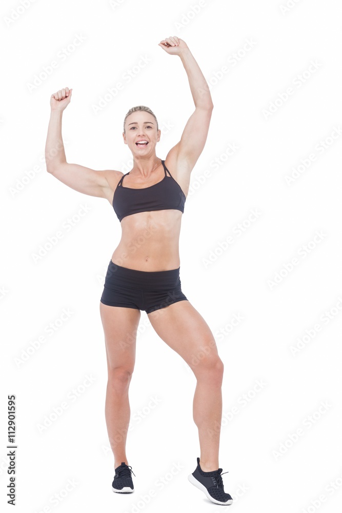 Female athlete raising arms on white background