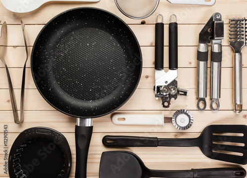 cookware and accessories on a wooden table. photo