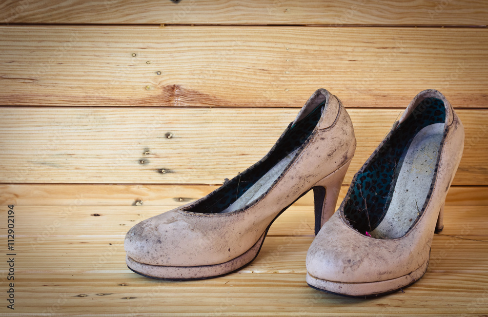 Still life with old pink shoes on wooden backgrounds Still life with old pink shoes on wooden backgrounds