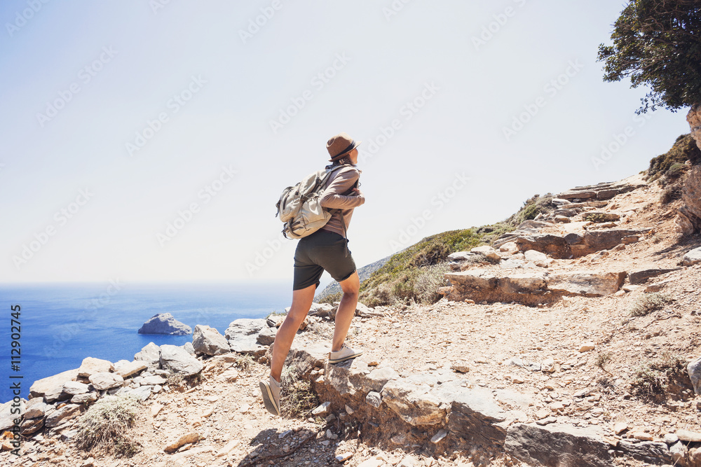 Hiker traveler girl on a hiking trail, travel and active lifestyle concept