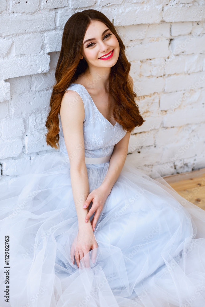 Fototapeta premium Bride in a tender light blue wedding dress in a morning. Fashion beauty portrait