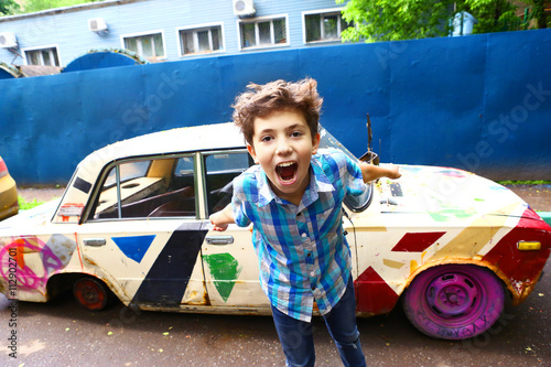 boy on the old painted retro car background photo