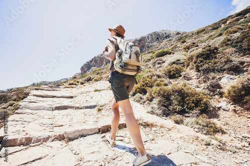 Hiker traveler woman on a hiking trail  travel and active lifestyle concept