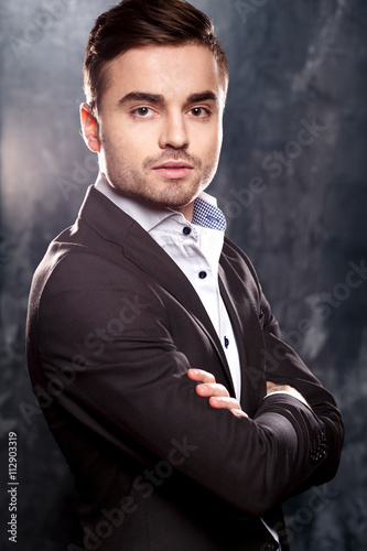 Close-up portrait of handsome elegant young man in a suit