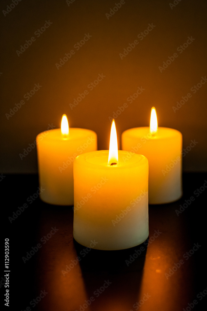 closeup to burning candles in darkness closeup to burning candles in darkness