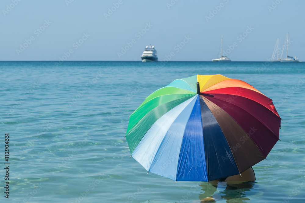 colorful umbrella with blue sky and sea background