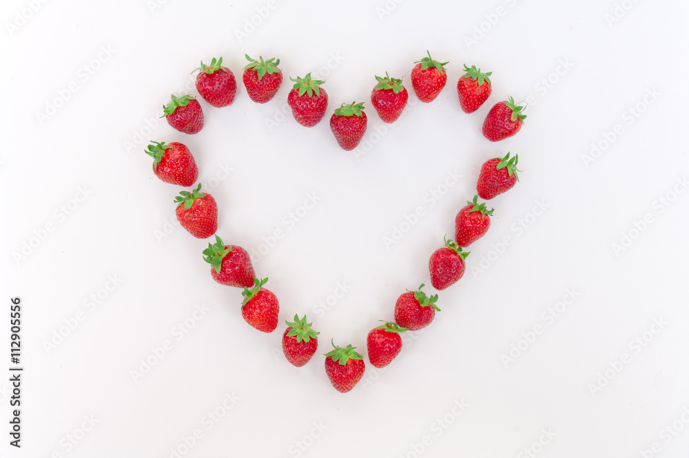 Heart shaped strawberries on white background strawberry heart