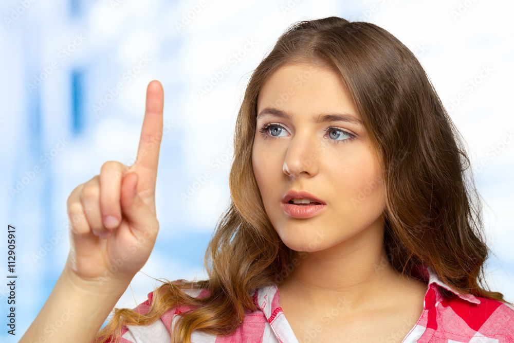 Beautiful happy smiling woman pointing up Beautiful happy smiling woman pointing up