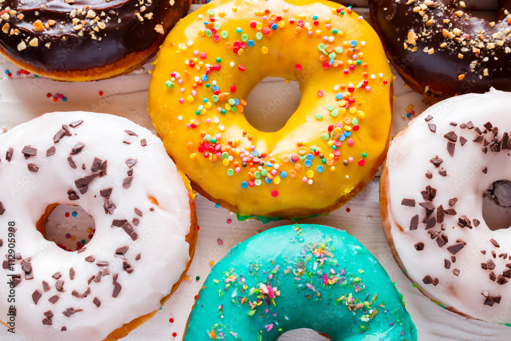 colorful fresh donuts on a white background