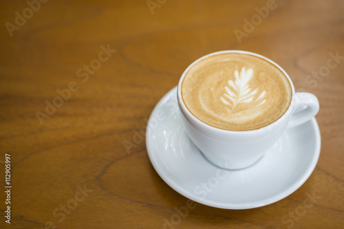 cappuccino cup on wood background