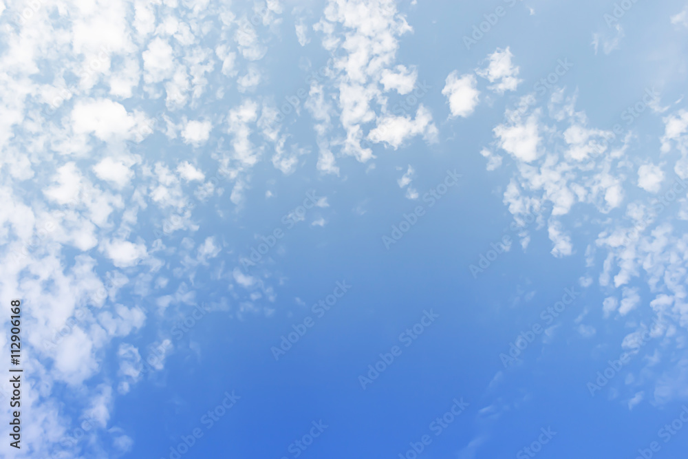white clouds and blue sky background, soft focus.