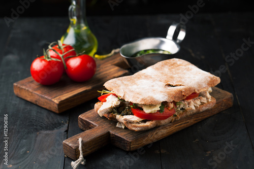 Sandwich with meat, pesto and goat cheese