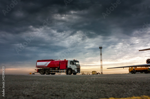 Aircraft fueler on the cloudy morning airport apron photo