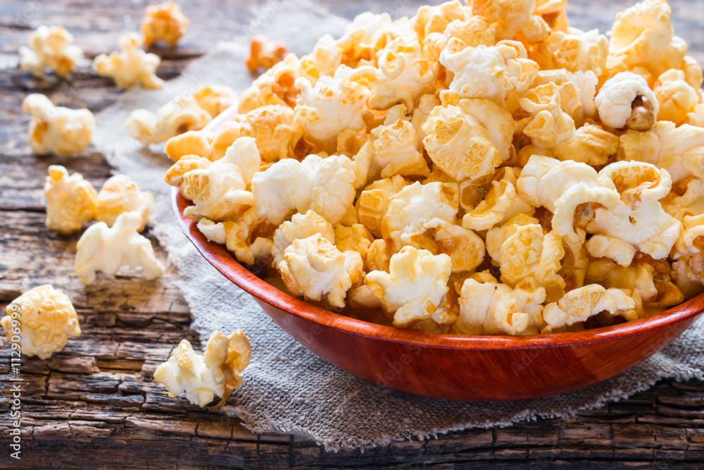 Plate with sweet popcorn on a napkin closeup Plate with sweet popcorn on a napkin closeup