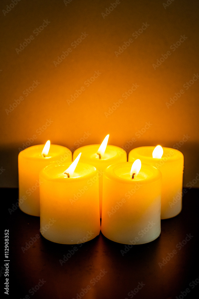 closeup to burning candles in darkness closeup to burning candles in darkness