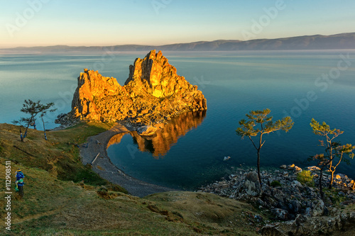 The rays of rising sun illuminate the rock Shamanka photo