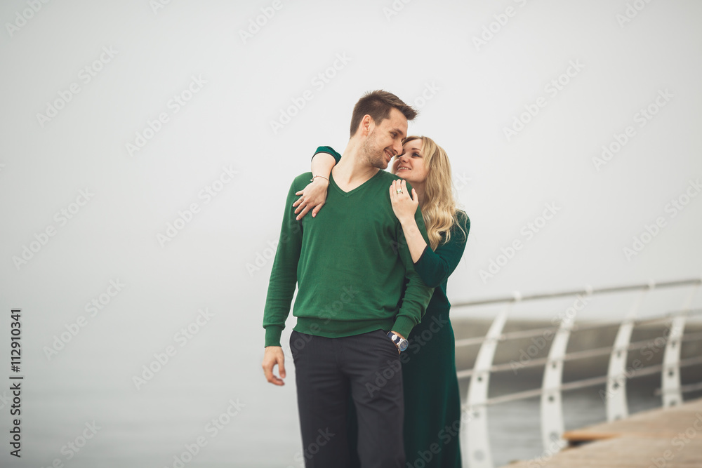 Lovely couple kissing and hugging on a sea dock Lovely couple kissing and hugging on a sea dock
